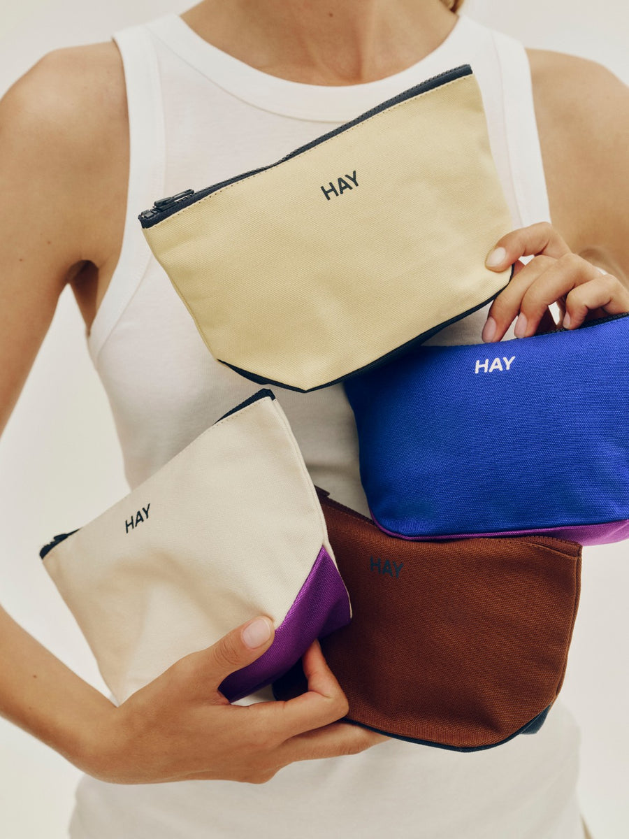 Travel Pouch, Small, Yellow by HAY, held in a range of colours