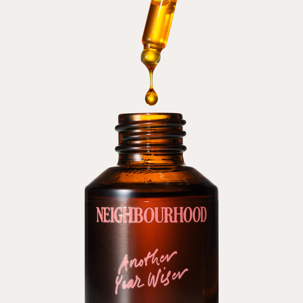 Another Year Wiser Facial Oil, 30ml by Neighbourhood Botanicals, with oil dropping from the pipette