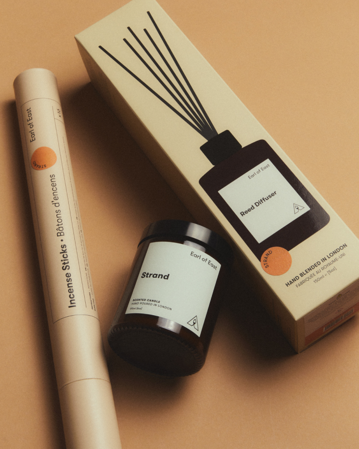 Strand Scent Layering Set by Earl of East, on a tan background