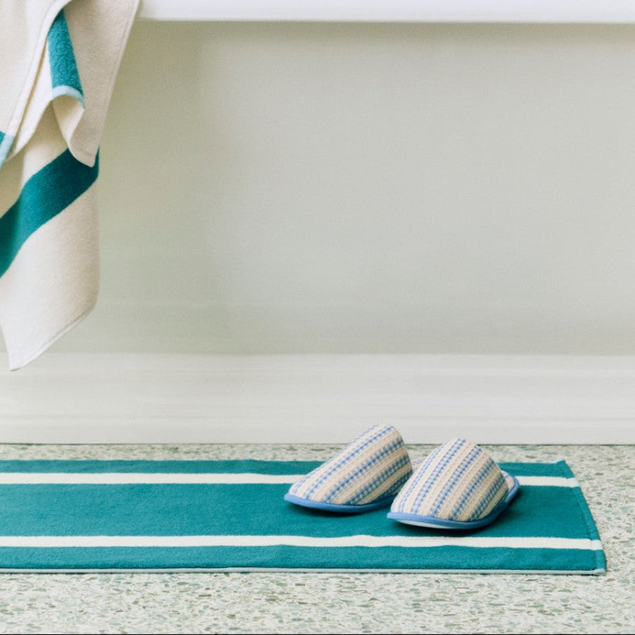 Waffle Slippers, Stripe, Dusty Blue by HAY, on a bathroom floor