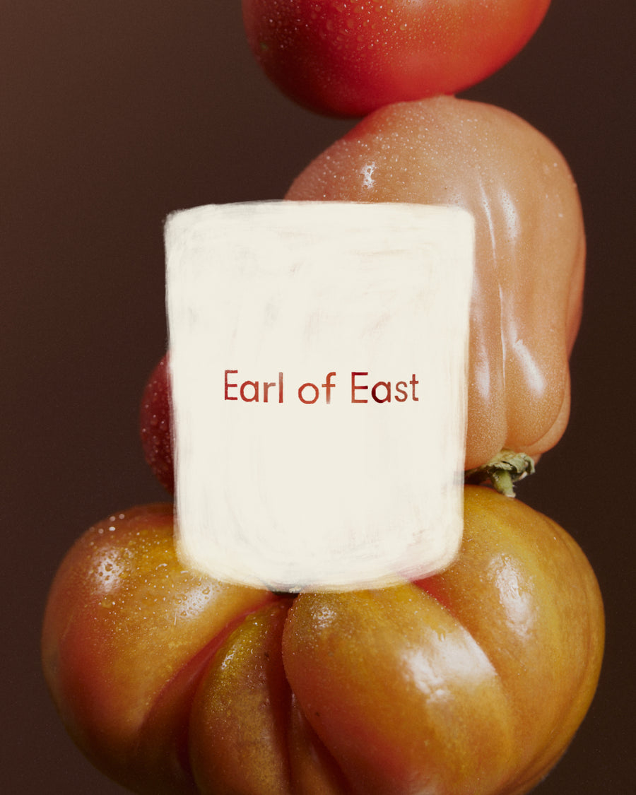 Greenhouse Scented Candle, 260ml by Earl of East, against stacked heirloom tomatoes