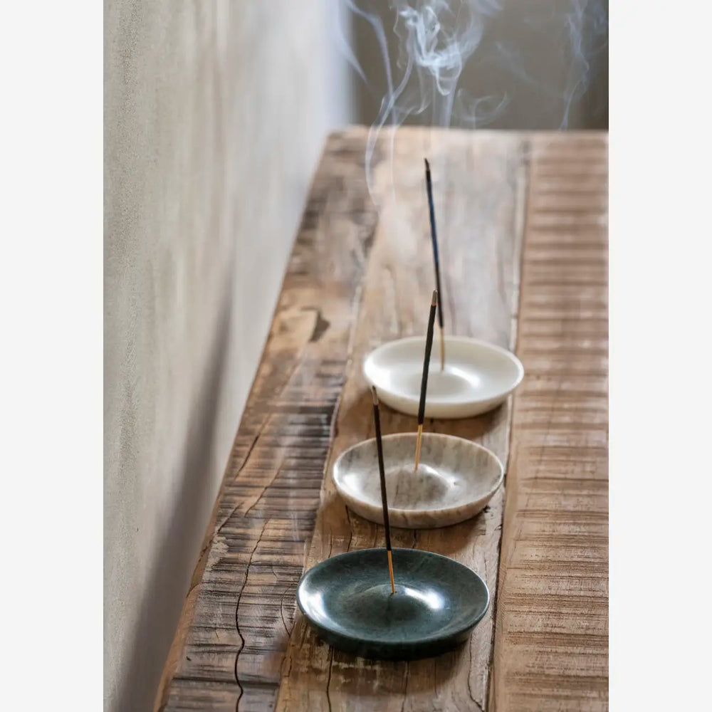 Round Marble Incense Holder, Beige by Madam Stoltz, holding incense on a wooden shelf
