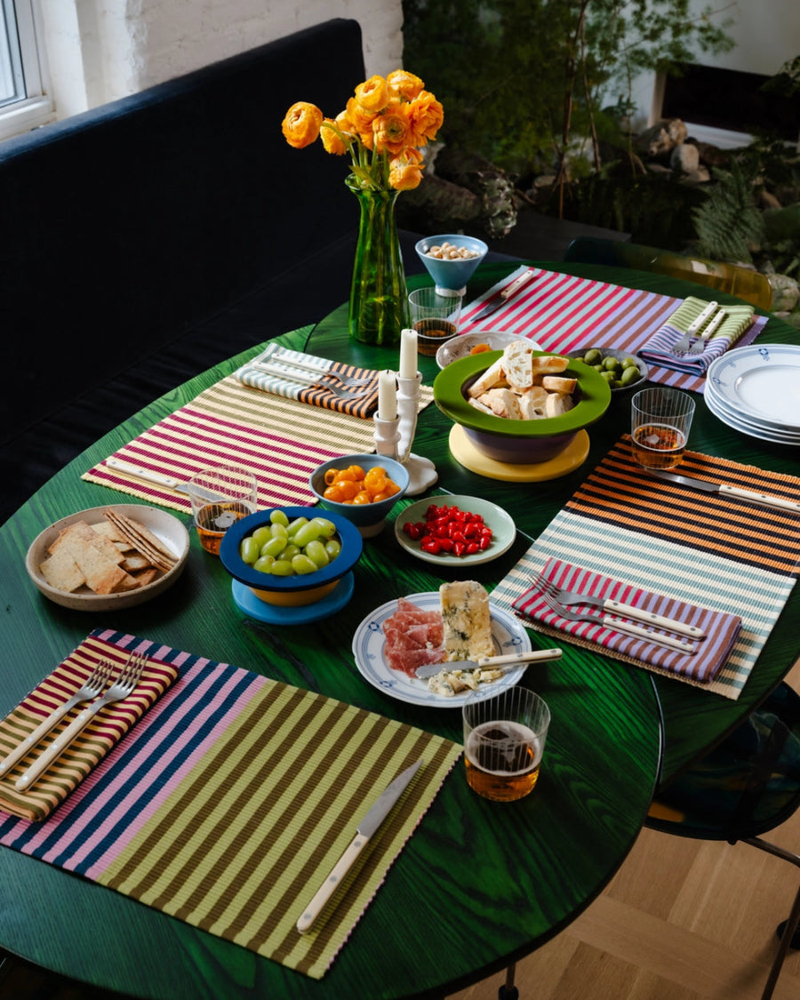 Duo Stripe Placemat, Honey by Dusen Dusen, on a dining table set for a meal