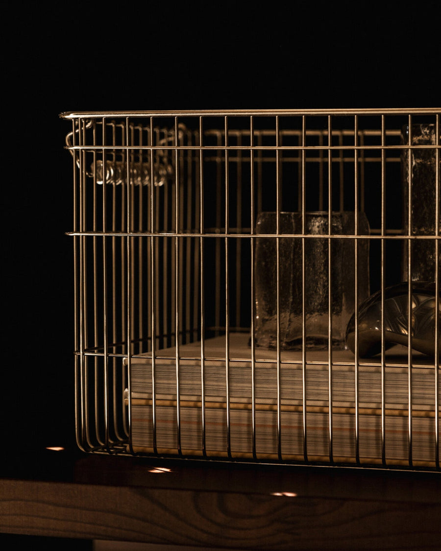 Cala Stackable Baskets, Set of 2, Stainless Steel by ferm LIVING, holding towels in a dark room