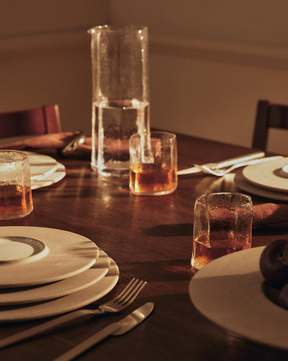 Kiru Carafe, Clear by ferm LIVING, on a candlelit dining table