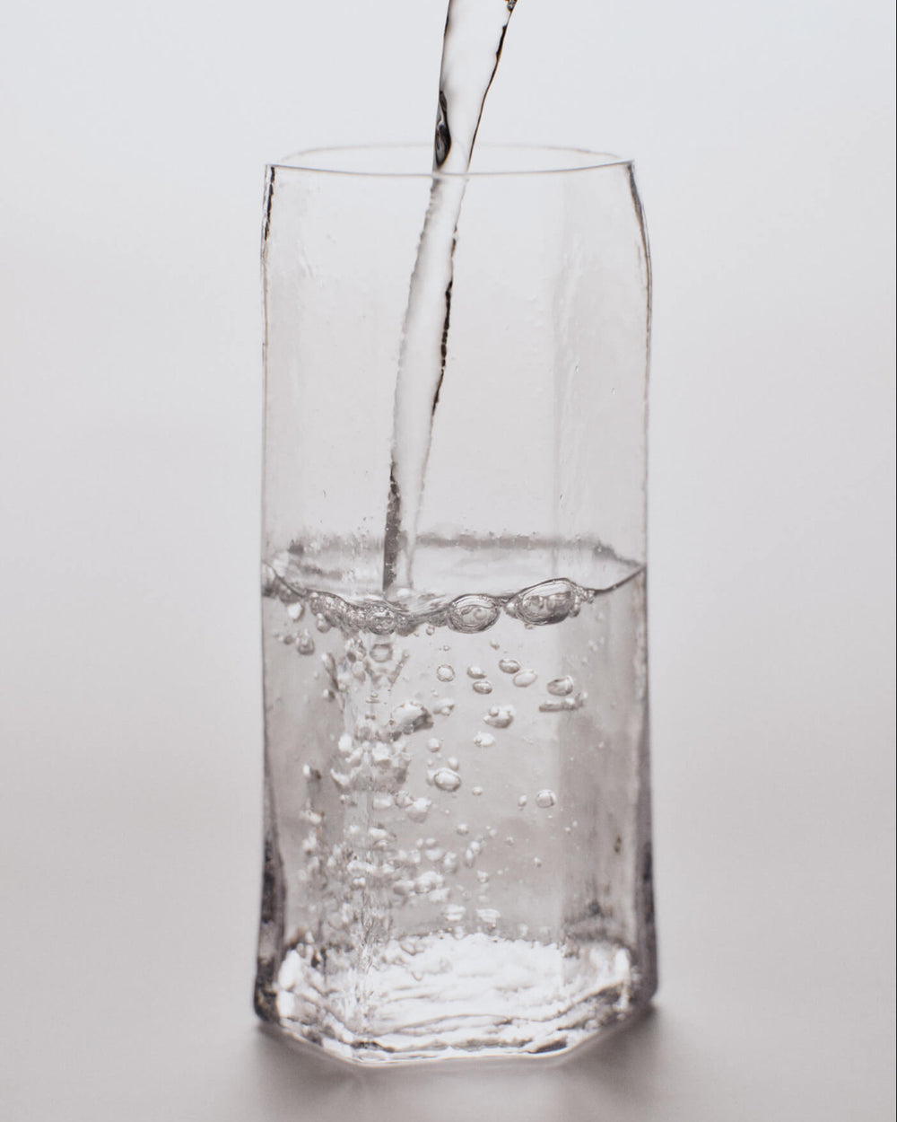 Kiru Tall Glasses, Set of 2, Clear by ferm LIVING, with water being poured
