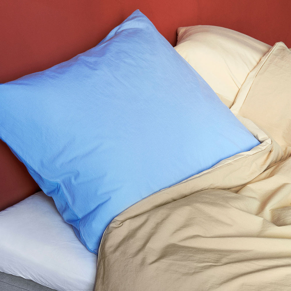 Duo Duvet Cover, 200 x 200, Cappuccino by HAY, with a blue pillow