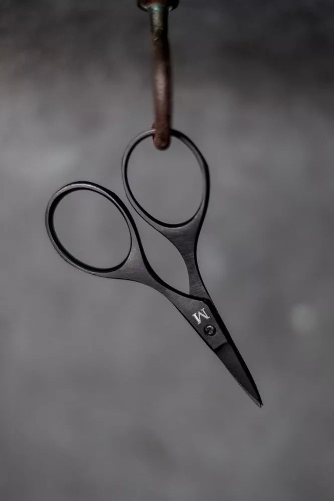Baby Bow Scissors by Merchant and Mills, hanging on a grey background