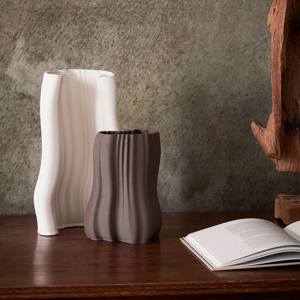 Moire Vase Anthracite, Small by ferm LIVING, with other vases on a table