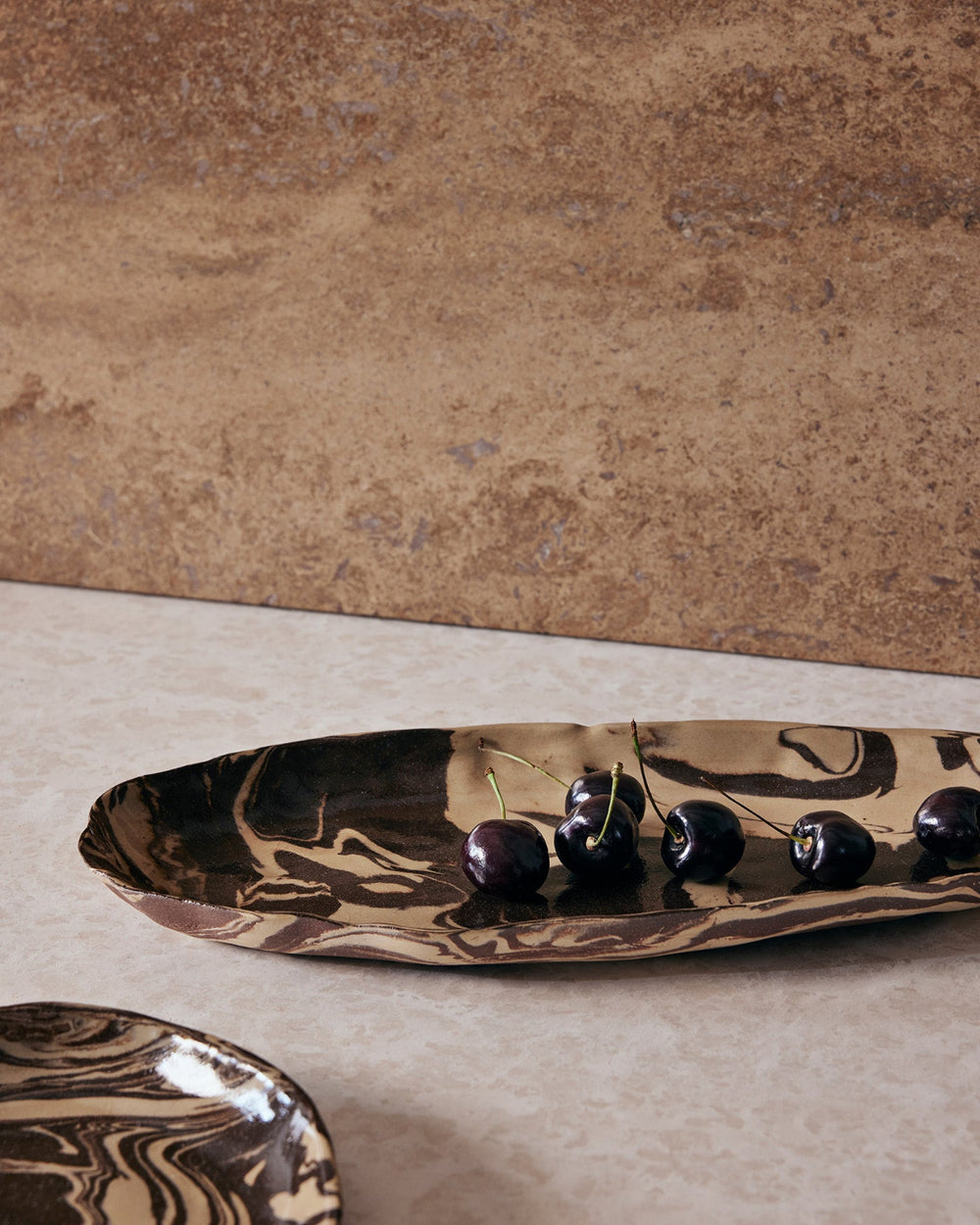 Ryu Platter, Sand/Brown, 37cm by ferm LIVING, on a stone surface