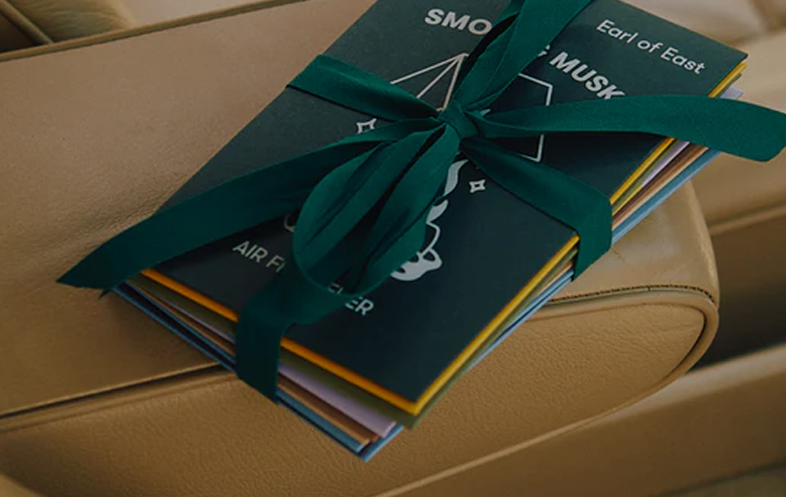 Earl of East gift card in a green gift envelope on a car seat