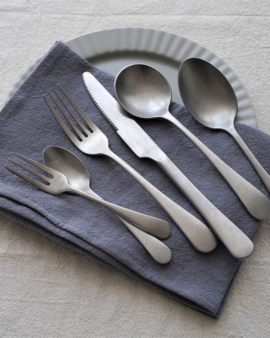 Stonewashed Stainless Steel Cutlery by Gohobi, on a grey napkin