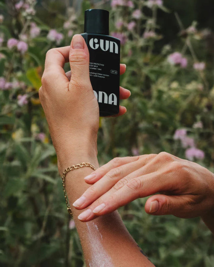 Body Milk Spf 30, 100mL by Gun Ana, being applied to an arm