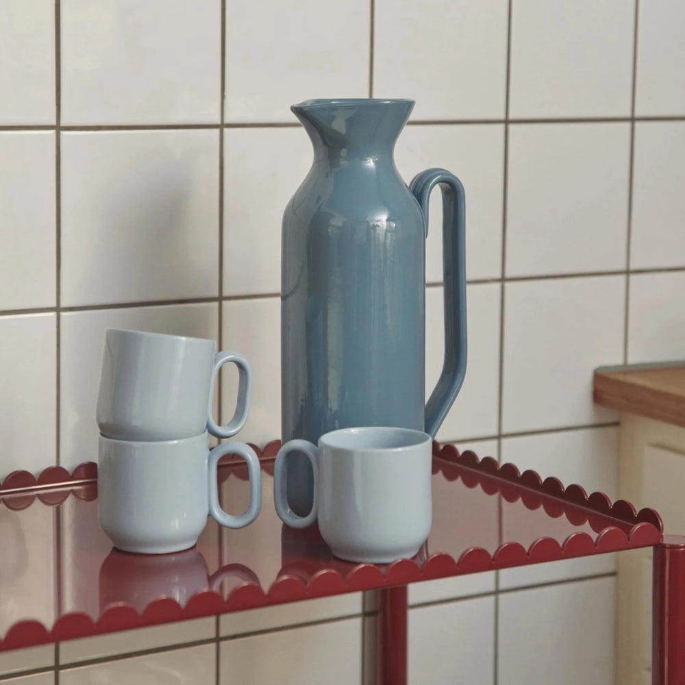 Barro Jug, Tall, Dark Blue by HAY, with cups on a tiled kitchen counter