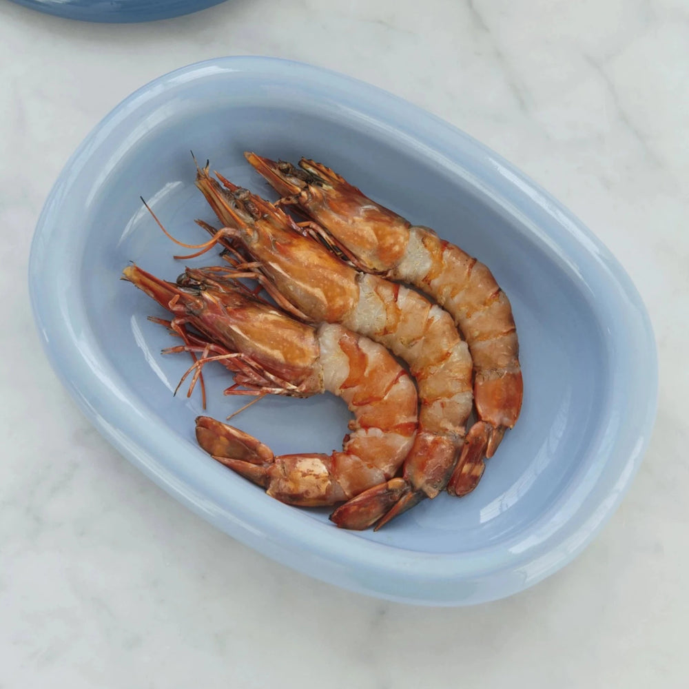 Barro Oval Dish, Small, Light Blue by HAY, holding cooked prawns