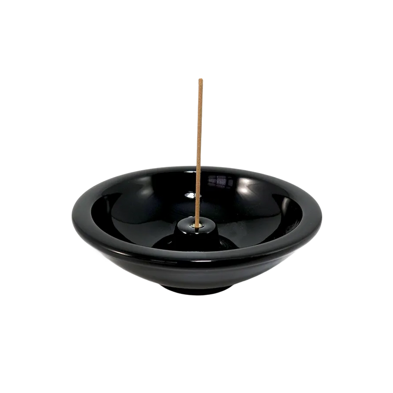  Ceramic Incense Wheel, Ebony by Shoyeido Incense, holding a burning incense stick 
