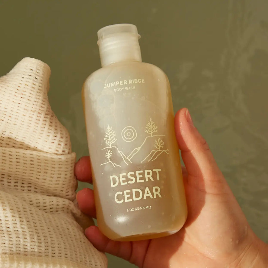Desert Cedar Body Wash, 236.5ml by Juniper Ridge, held in hand