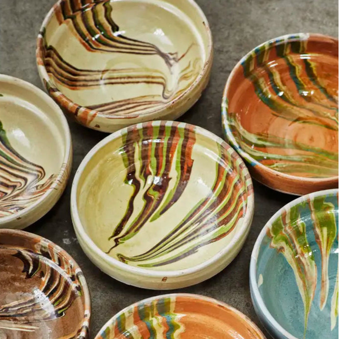 Hand-glazed bowls with green and orange swirls