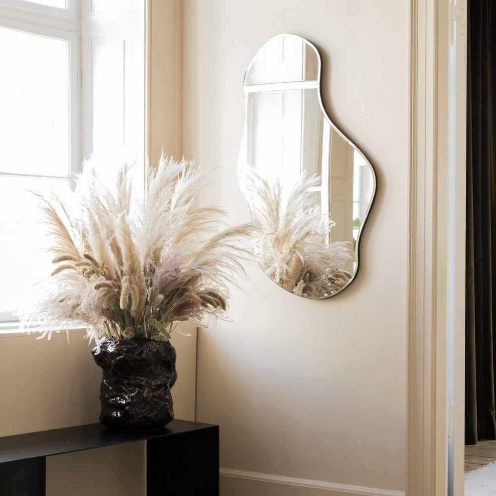Pond Mirror, Large, Brass by ferm LIVING, above a console with dried grasses