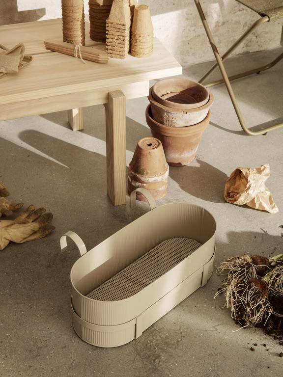 Bau Balcony Box by ferm LIVING, on a balcony railing holding plants