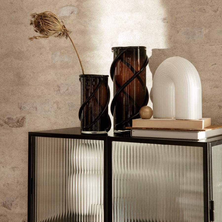 Vuelta Table Lamp by ferm LIVING, on a console with vases