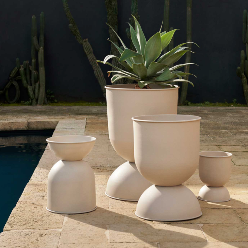 Hourglass Pots, Various Sizes, Cashmere by ferm LIVING, holding plants on a terrace