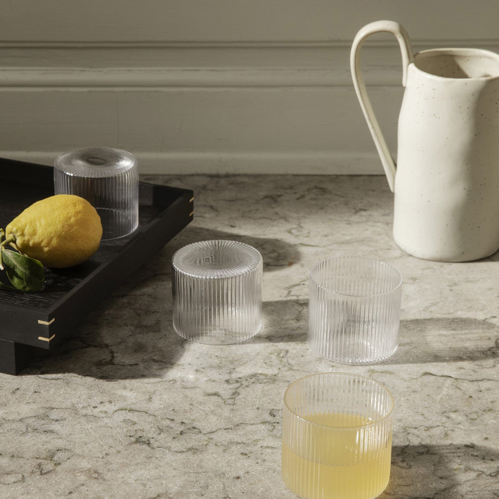 Flow Jug, Off-White Speckle by ferm LIVING, holding flowers in warm light