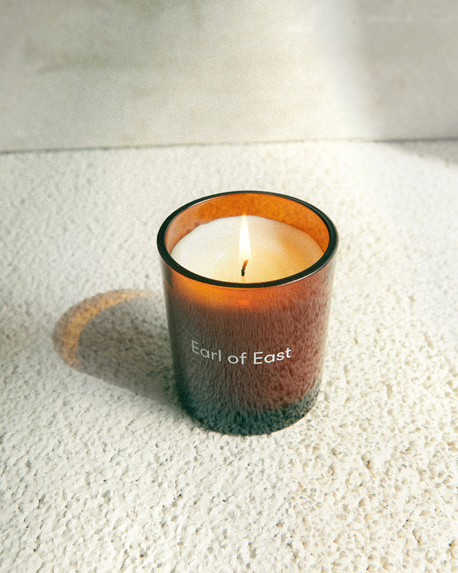 Wildflower Scented Candle, 260ml by Earl of East, lit on a white surface