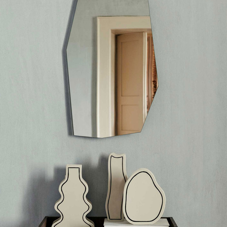 Shard Mirror, Small by ferm LIVING, on a wall above ornaments